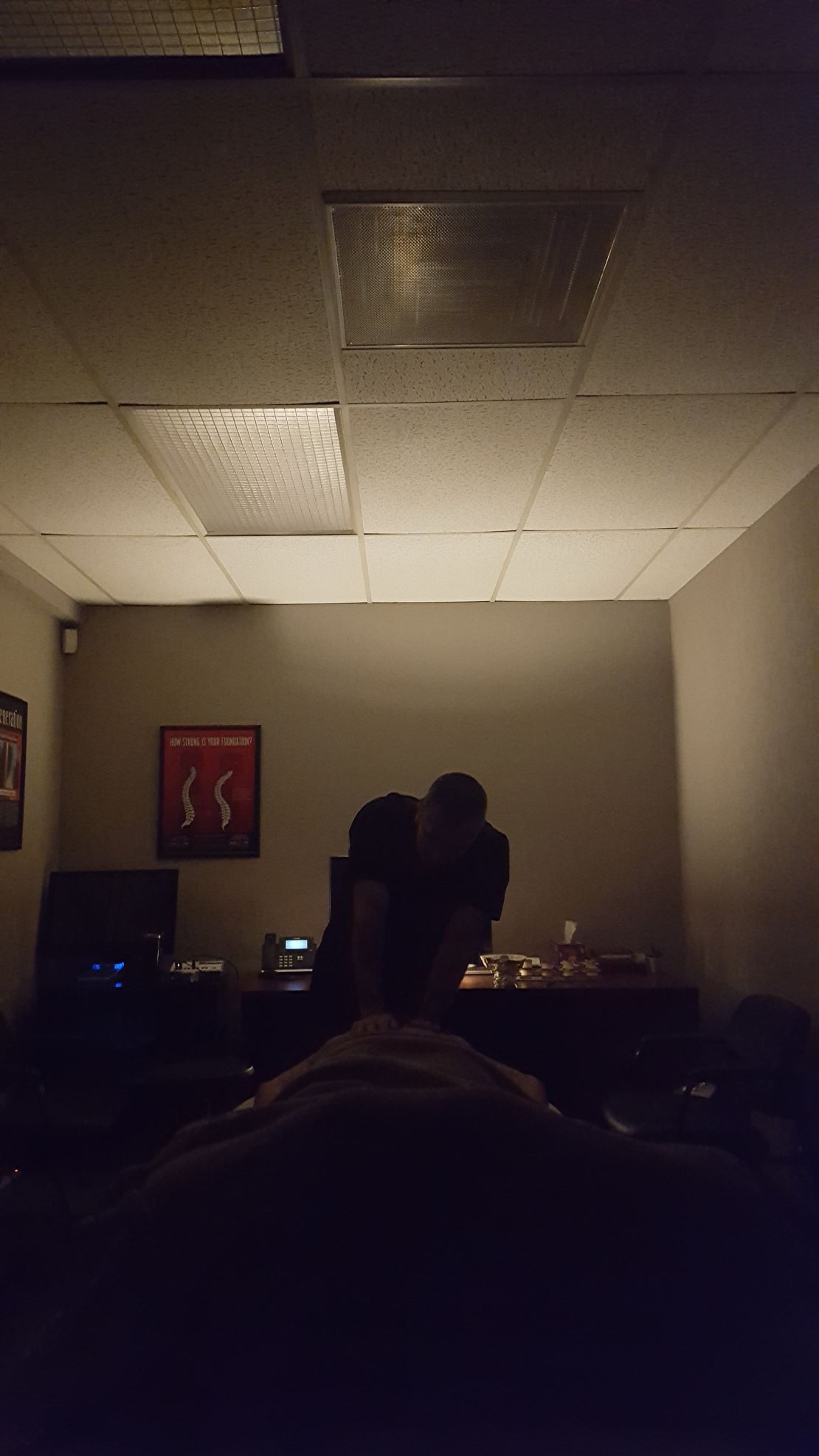 Massage in progress in dimly lit room