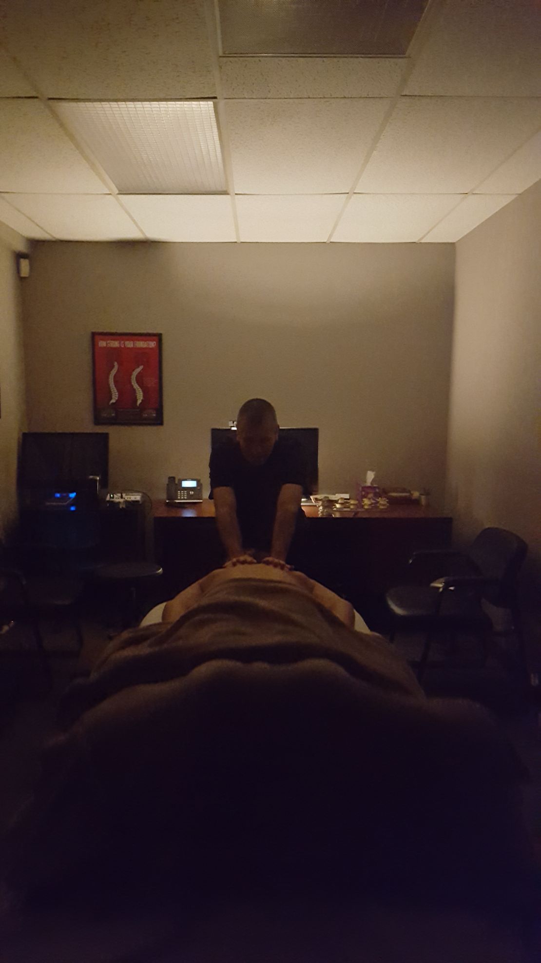 Massage in progress in dimly lit room